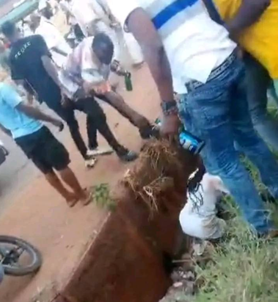 Outrage as masquerades brutally flog female nurse until she falls in a gutter in Enugu (video)